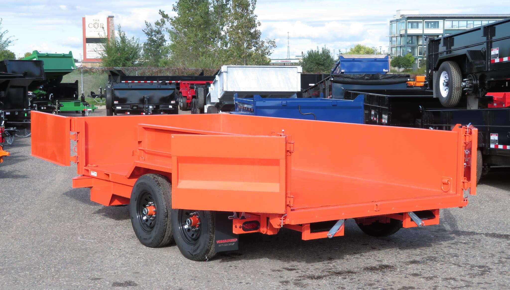 orange-garbage-truck-goes-to-the-dump-on-the-road-against-the